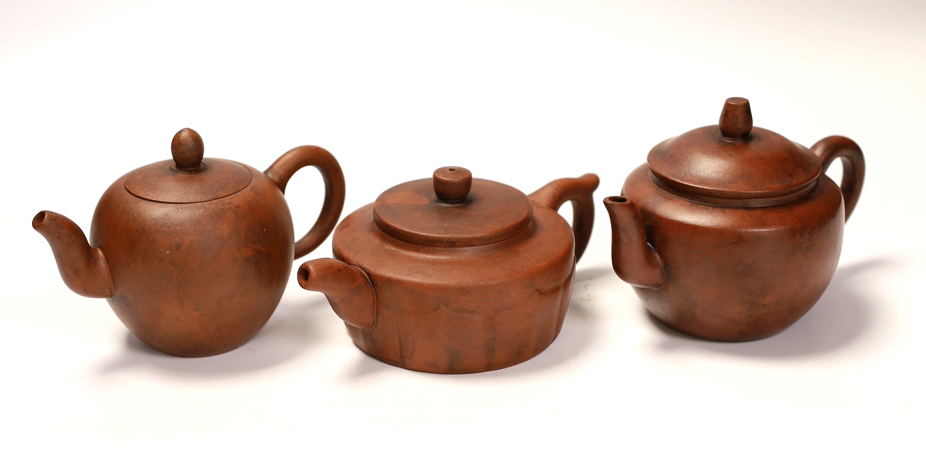 Three Chinese Yixing terracotta teapots, tallest 9cm